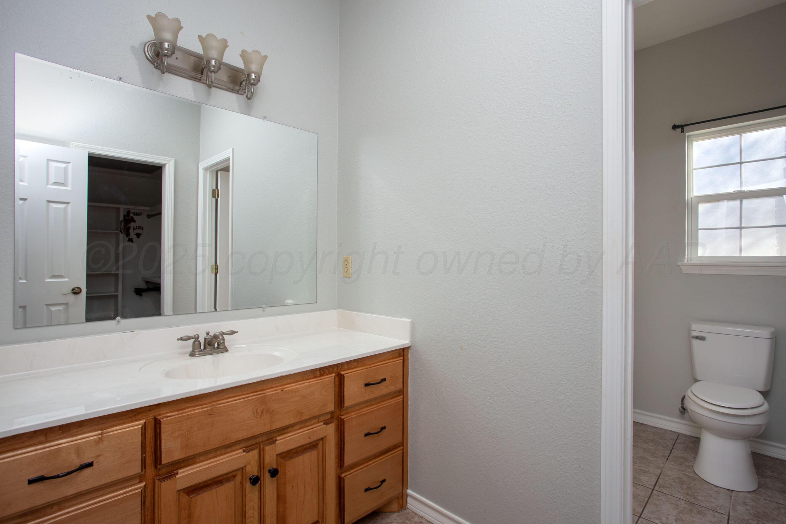 8900 Ottobahn Amarillo, TX 79119 - Photo 33 of 56 a bathroom with a sink vanity and a mirror