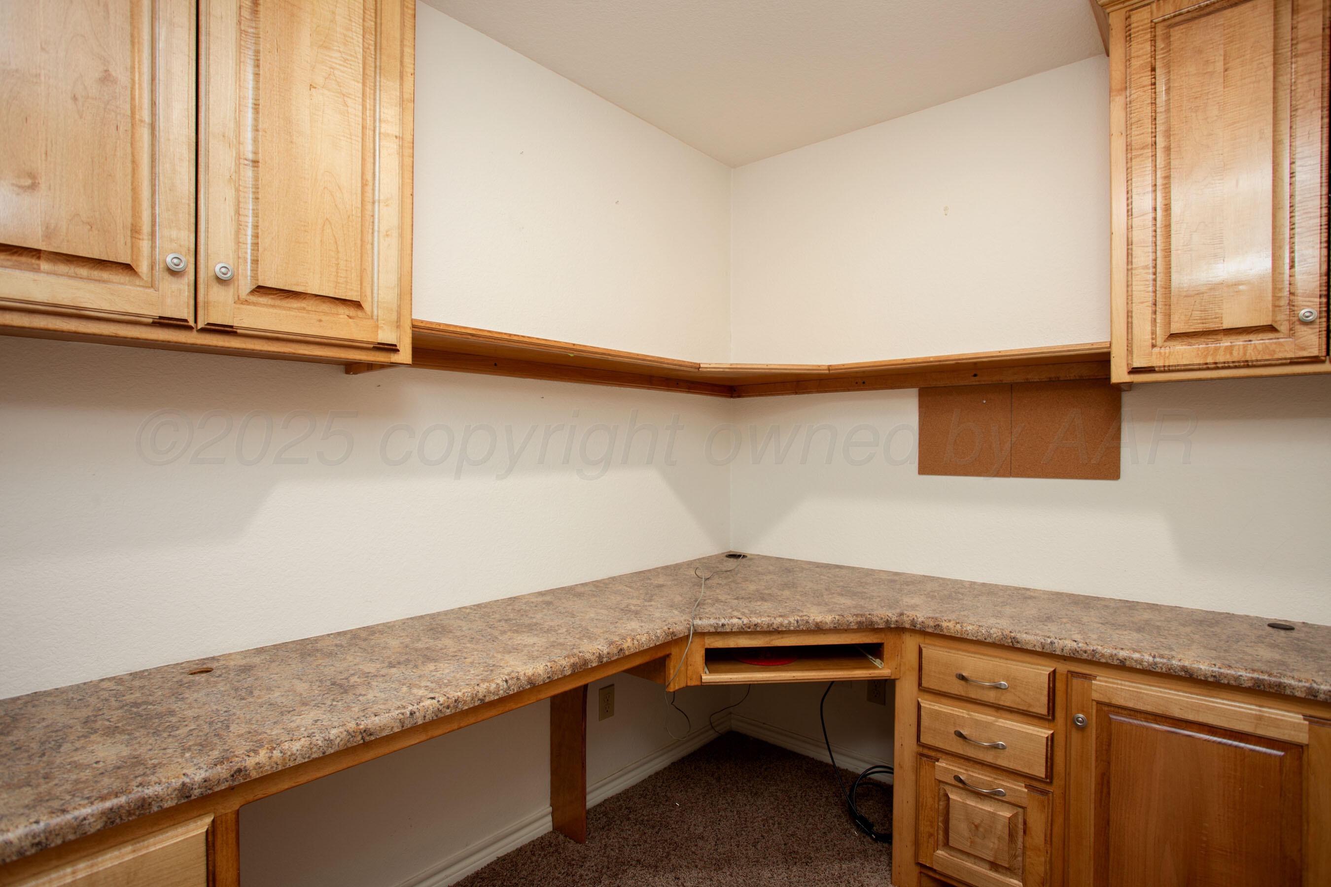 8900 Ottobahn Amarillo, TX 79119 - Photo 38 of 56 a kitchen with granite countertop cabinets sink and window