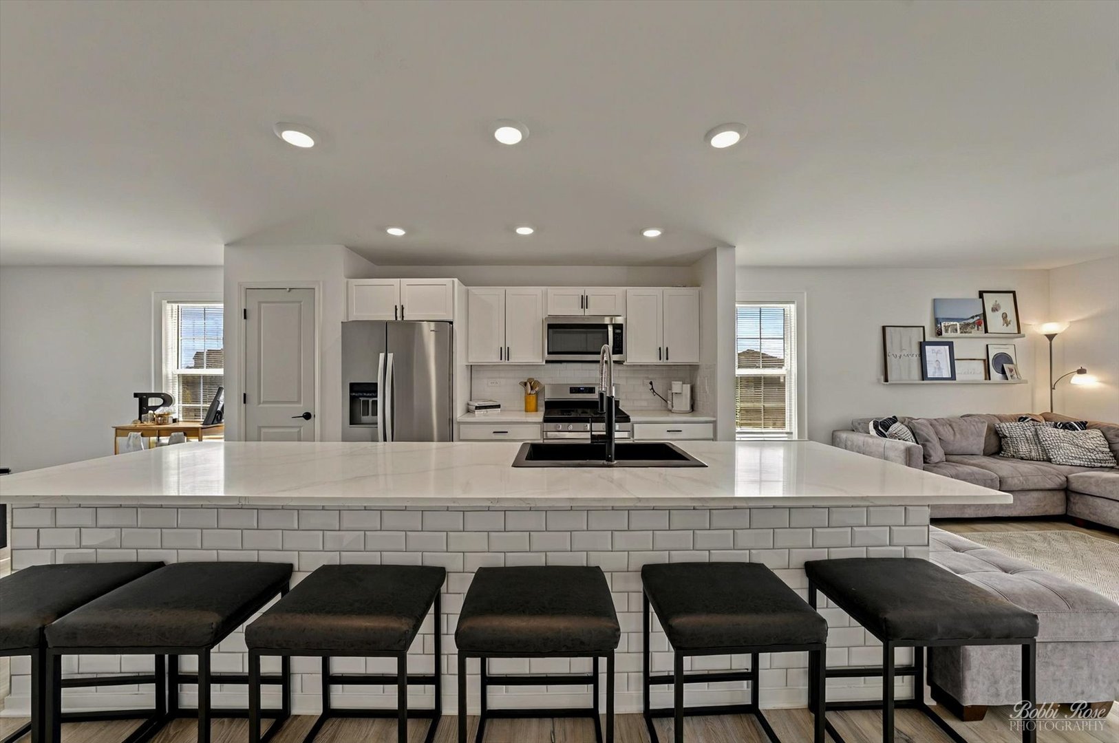 2451 Alison Avenue Pingree Grove, IL 60140 - Photo 11 of 47 a kitchen with granite countertop a table chairs sink and wooden floor