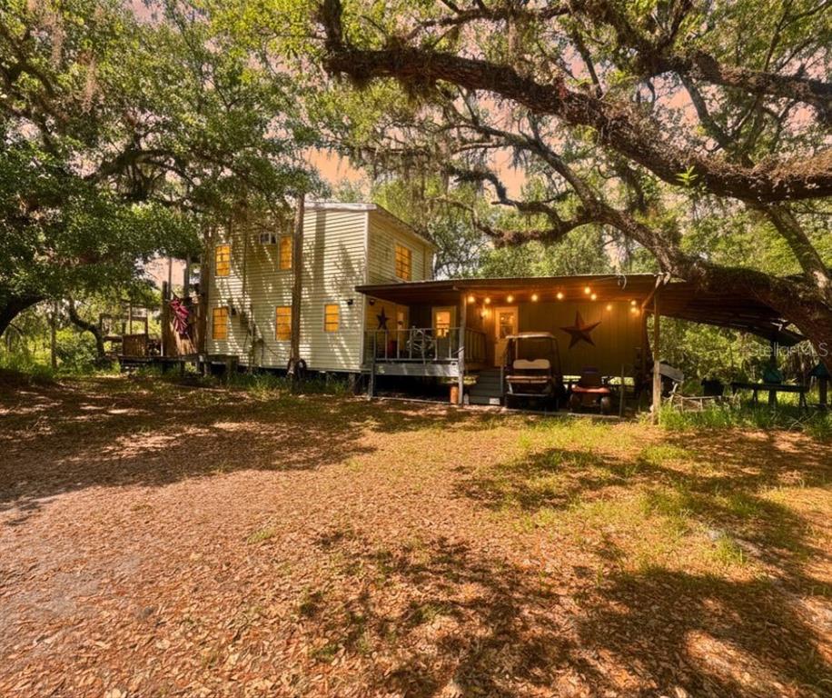 5379 Northeast River Bend Road Arcadia, FL 34266 - Photo 1 of 1 a view of road with large trees