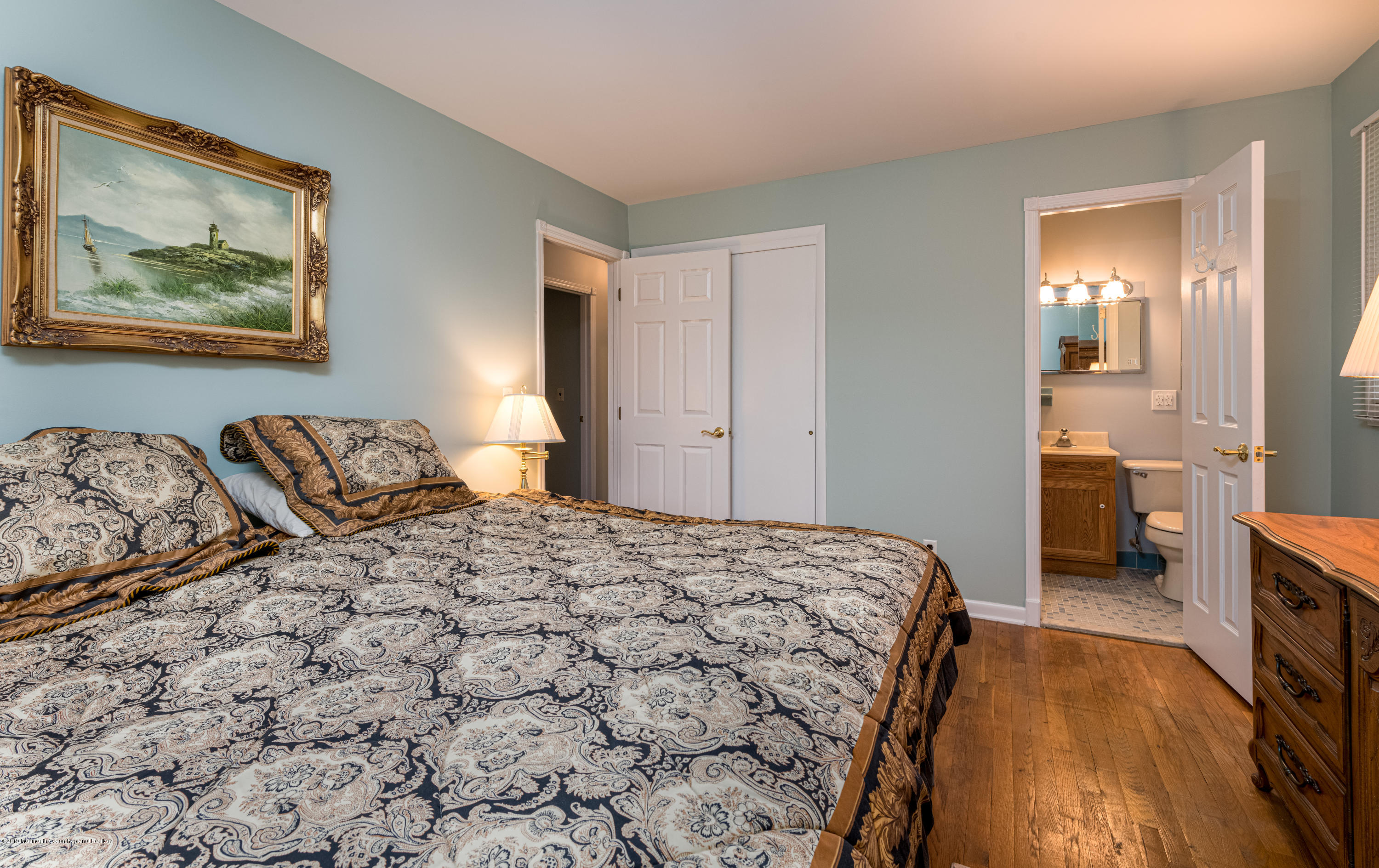 428 Brickyard Road Freehold, NJ 07728 - Photo 23 of 25 a bedroom with a large bed and a chandelier