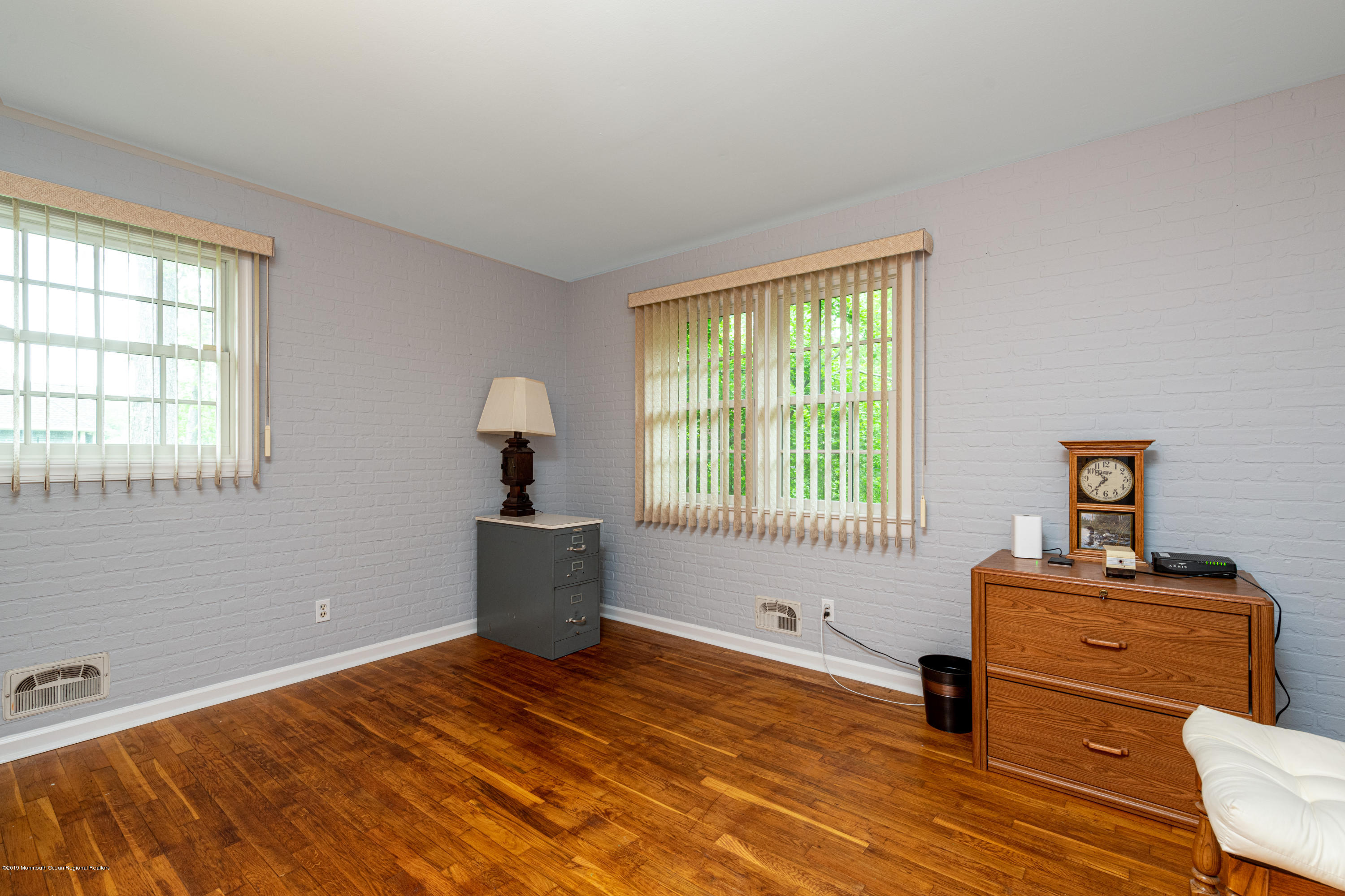 428 Brickyard Road Freehold, NJ 07728 - Photo 7 of 25 a bedroom with a bed and wooden floor