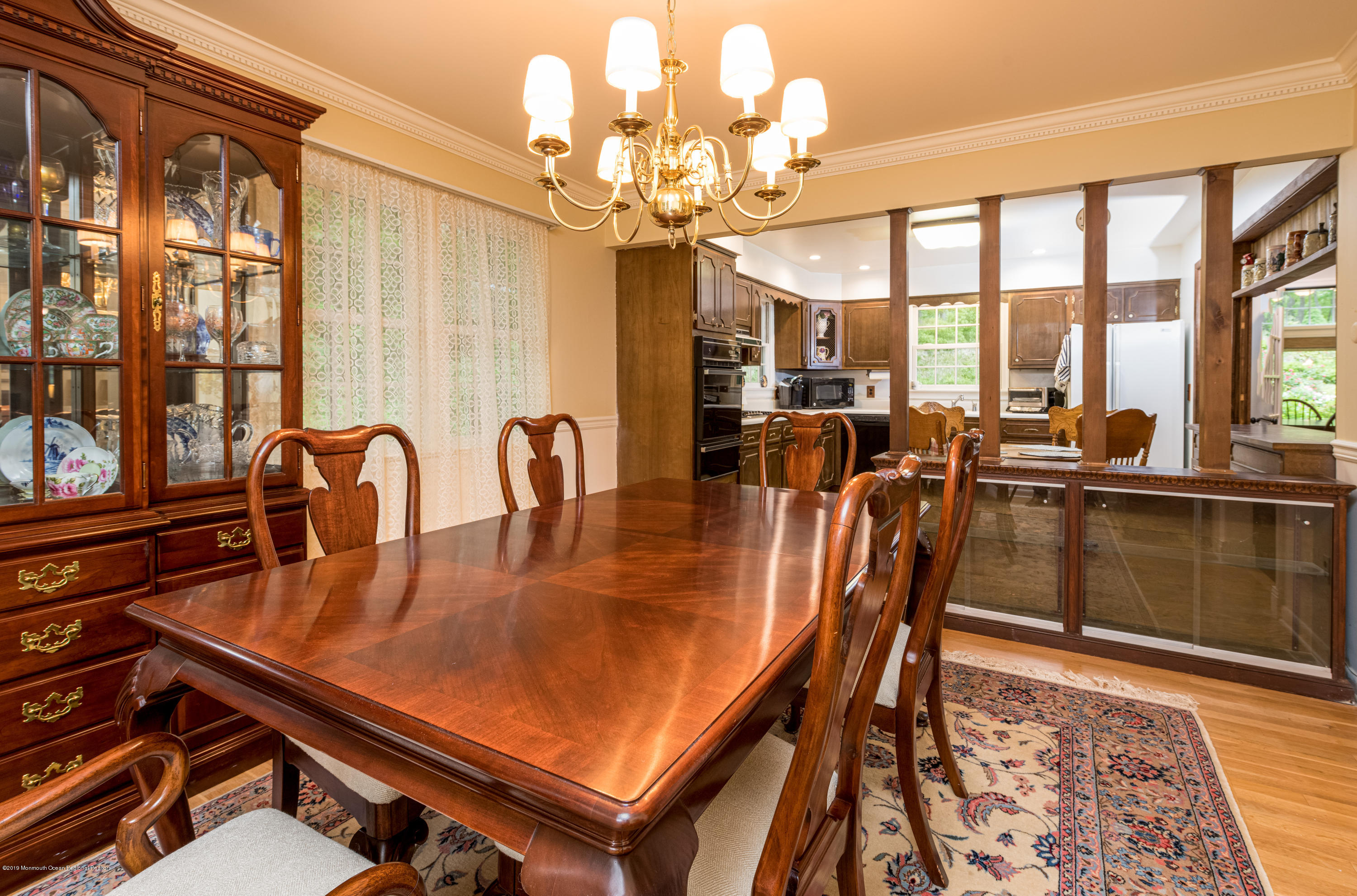 428 Brickyard Road Freehold, NJ 07728 - Photo 8 of 25 a dining room with furniture a chandelier and wooden floor