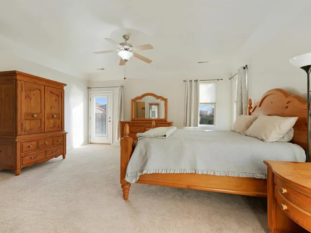 a bedroom with a bed and dresser