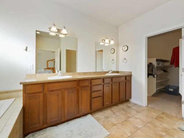 a spacious bathroom with a double vanity sink double and mirror