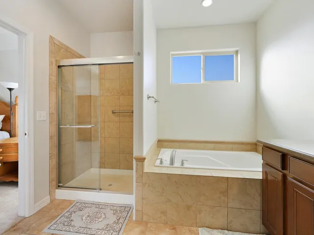 a bathroom with a bathtub and a shower