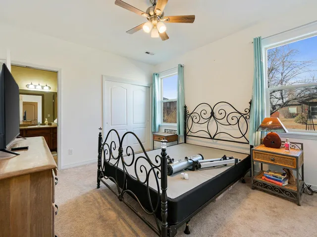 a bedroom with furniture and a chandelier