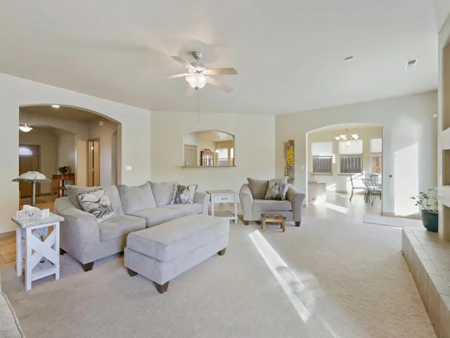 a living room with furniture and a chandelier