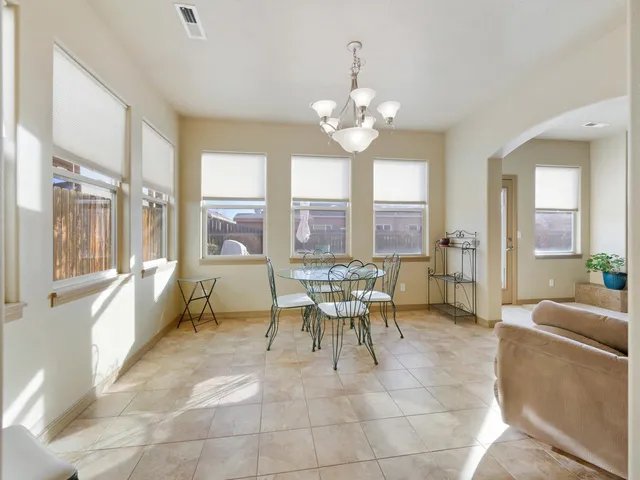 a dining room with furniture a chandelier and a rug