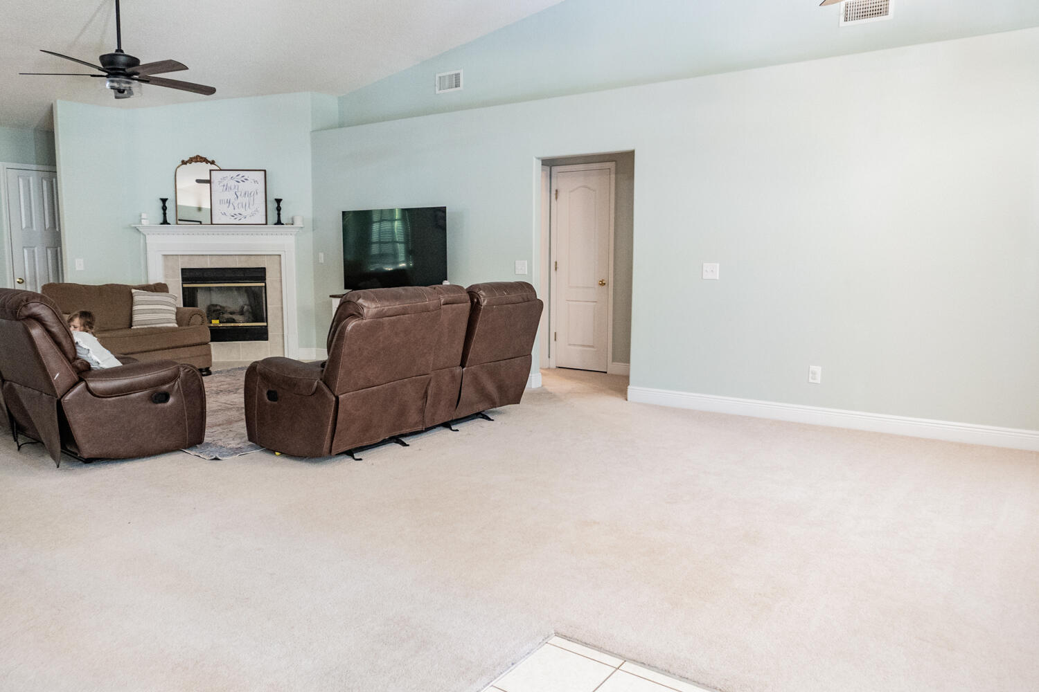 656 Territory Lane Crestview, FL 32536 - Photo 17 of 35 a living room with furniture a flat screen tv and a fireplace