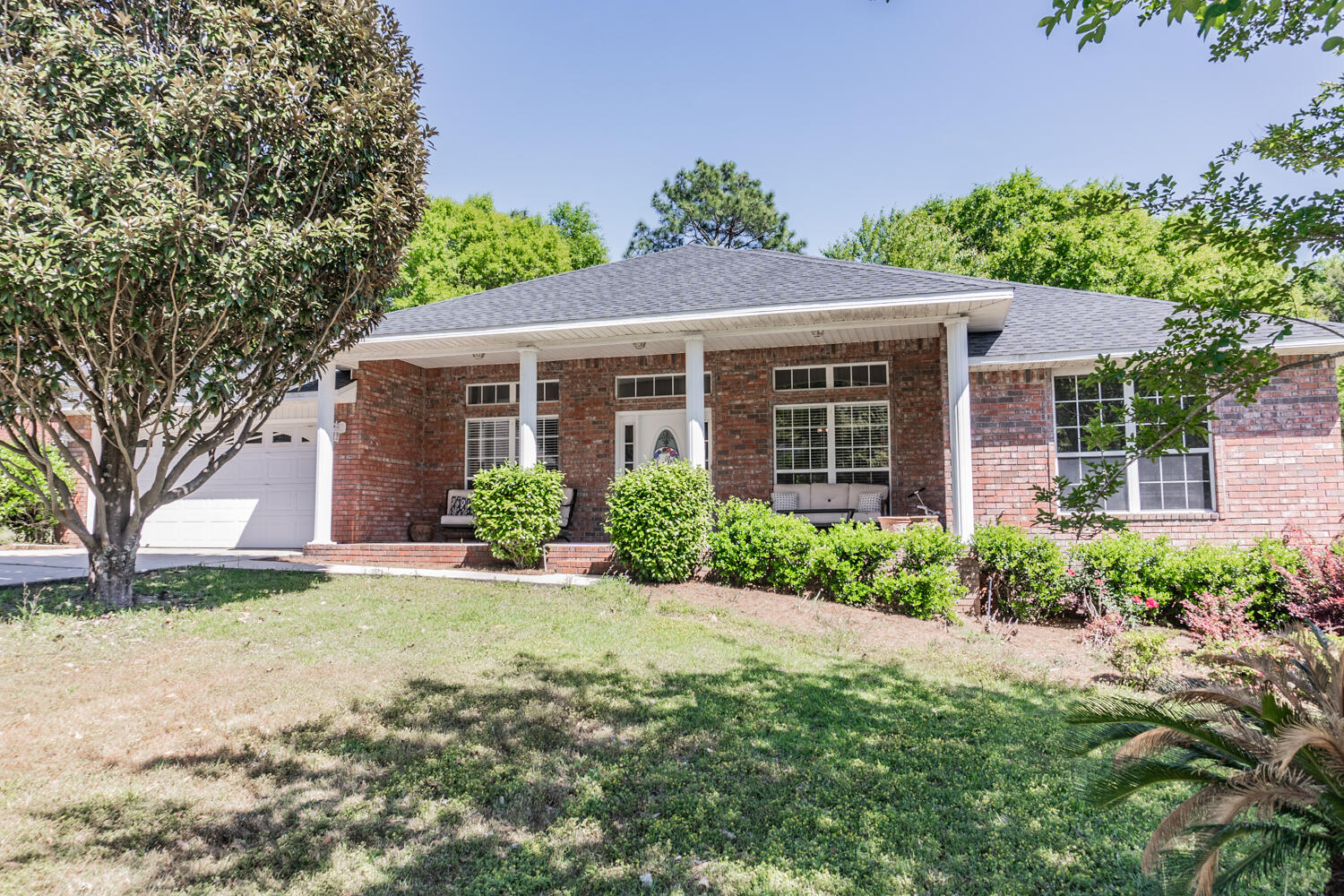 656 Territory Lane Crestview, FL 32536 - Photo 4 of 35 a front view of a house with a yard and potted plants