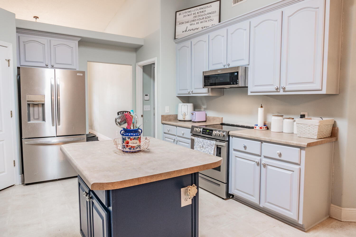 656 Territory Lane Crestview, FL 32536 - Photo 9 of 35 a kitchen with stainless steel appliances granite countertop a refrigerator a stove a sink and white cabinets