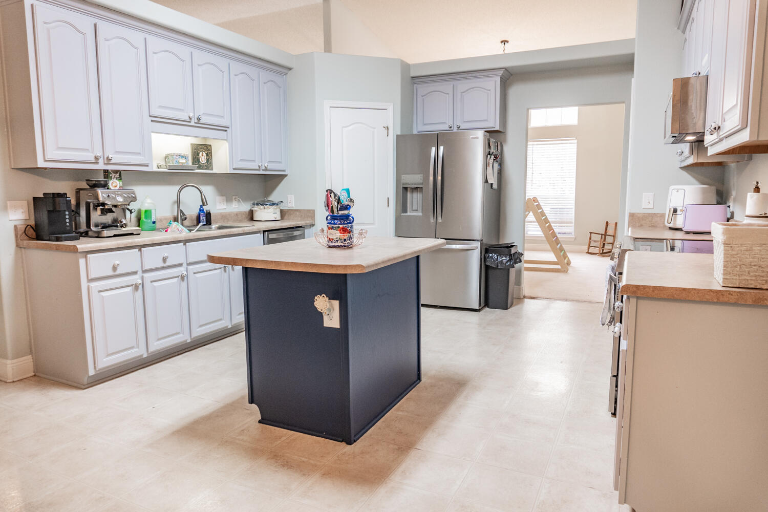 656 Territory Lane Crestview, FL 32536 - Photo 10 of 35 a kitchen with stainless steel appliances granite countertop a refrigerator a stove a sink dishwasher and white cabinets with wooden floor