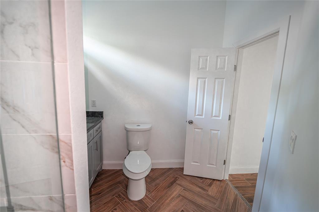 a bathroom with a toilet and a shower