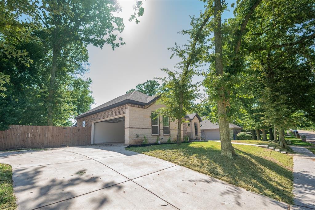 1408 Spinnaker Lane Azle, TX 76020 - Photo 3 of 8 View of front facade featuring brick siding, driveway, and a garage
