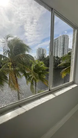 a bathroom with a shower sink vanity mirror and toilet