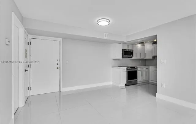 a kitchen with stainless steel appliances granite countertop a refrigerator stove and sink