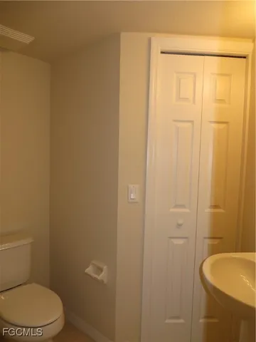 a white toilet sitting next to a shower