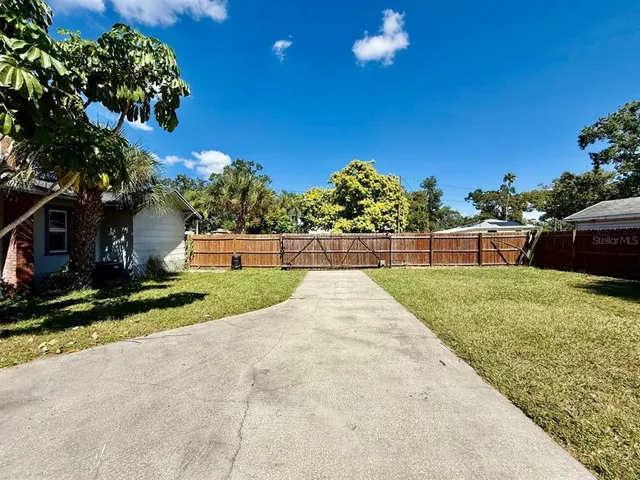 a front view of a house with a yard and a garage