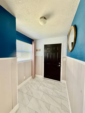 a bedroom with a bed and a mirror