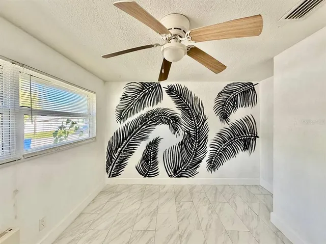 a view of a room with plants and wooden floor