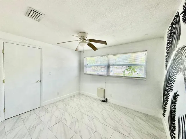 a view of empty room with windows