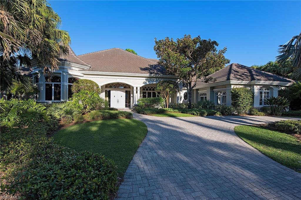 2618 Bulrush Lane Naples, FL 34105 - Photo 16 of 19 a front view of a house with a yard