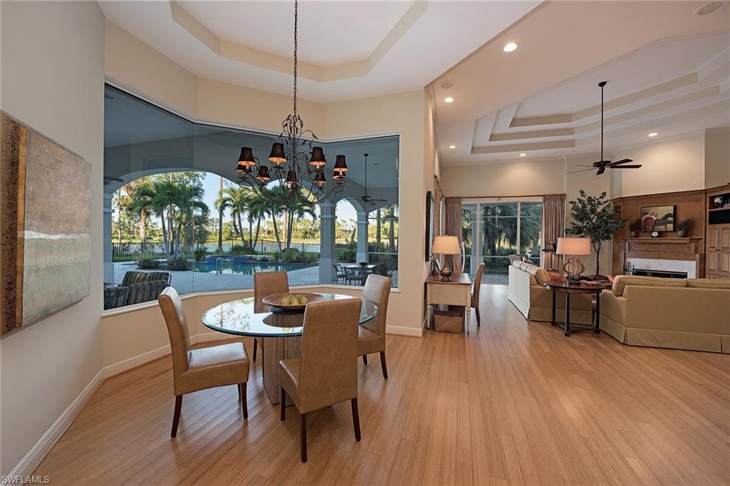 2618 Bulrush Lane Naples, FL 34105 - Photo 6 of 19 a dining room filled with furniture and wooden floor