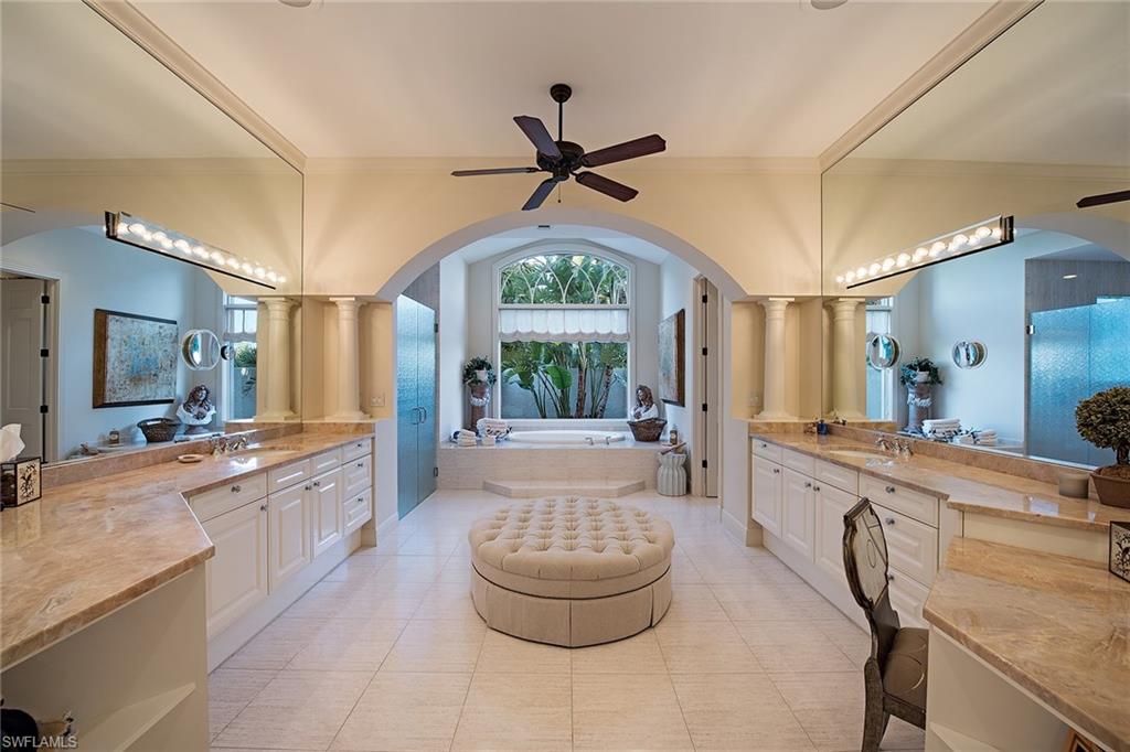 2618 Bulrush Lane Naples, FL 34105 - Photo 8 of 19 a large bathroom with a granite countertop tub sink and mirror
