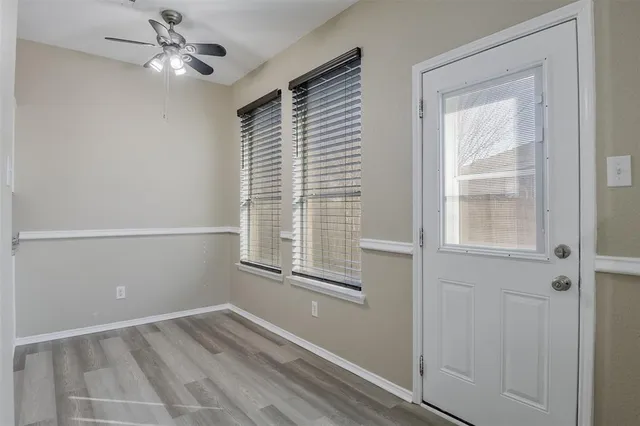 a view of empty room with ceiling fan