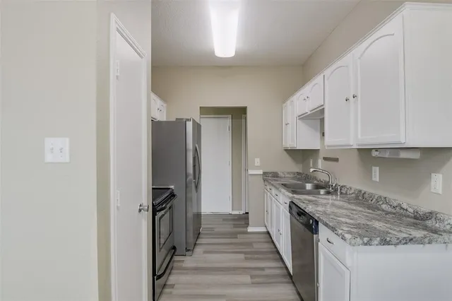 a kitchen with a stove and a refrigerator