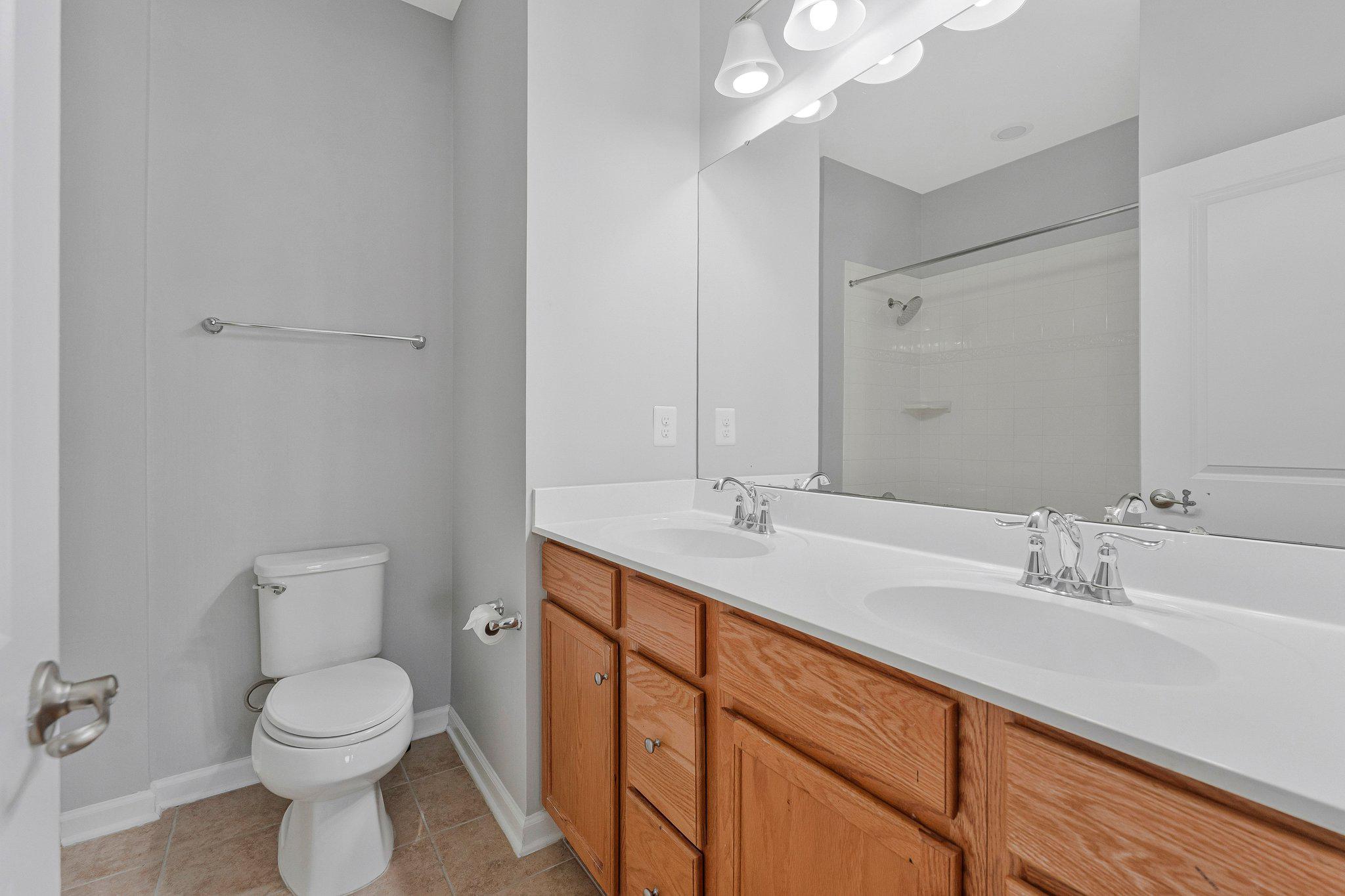 24977 Coats Square Aldie, VA 20105 - Photo 24 of 32 a bathroom with a toilet a sink a mirror and vanity