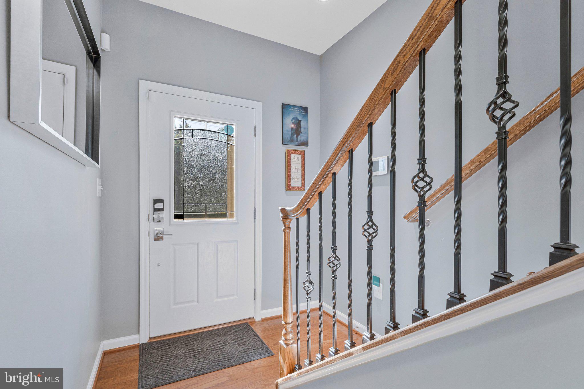 24977 Coats Square Aldie, VA 20105 - Photo 3 of 32 a view of staircase with lots of frames on wall and a window