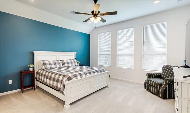 a bedroom with a bed and a couch