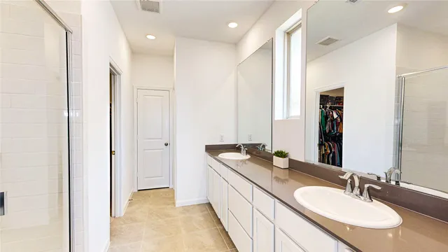 a bathroom with a double vanity sink and a mirror