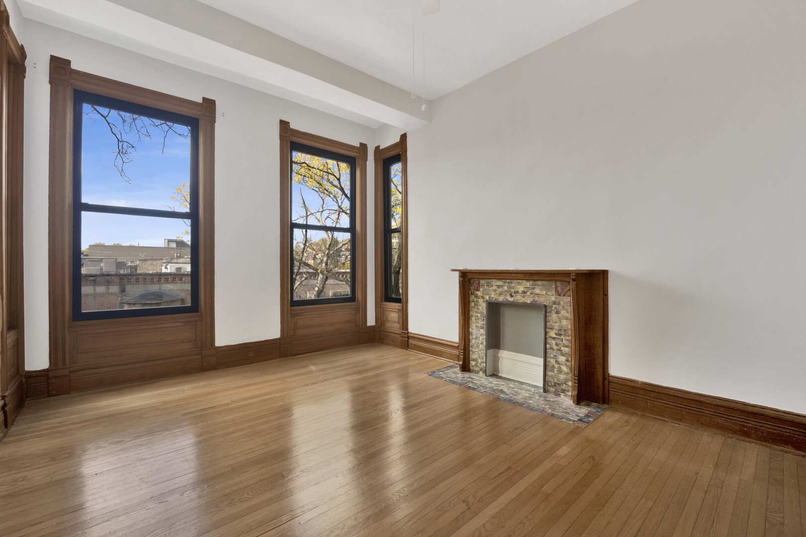 825 West Armitage Avenue, Unit 3S Chicago, IL 60614 - Photo 2 of 18 an empty room with wooden floor fireplace and windows