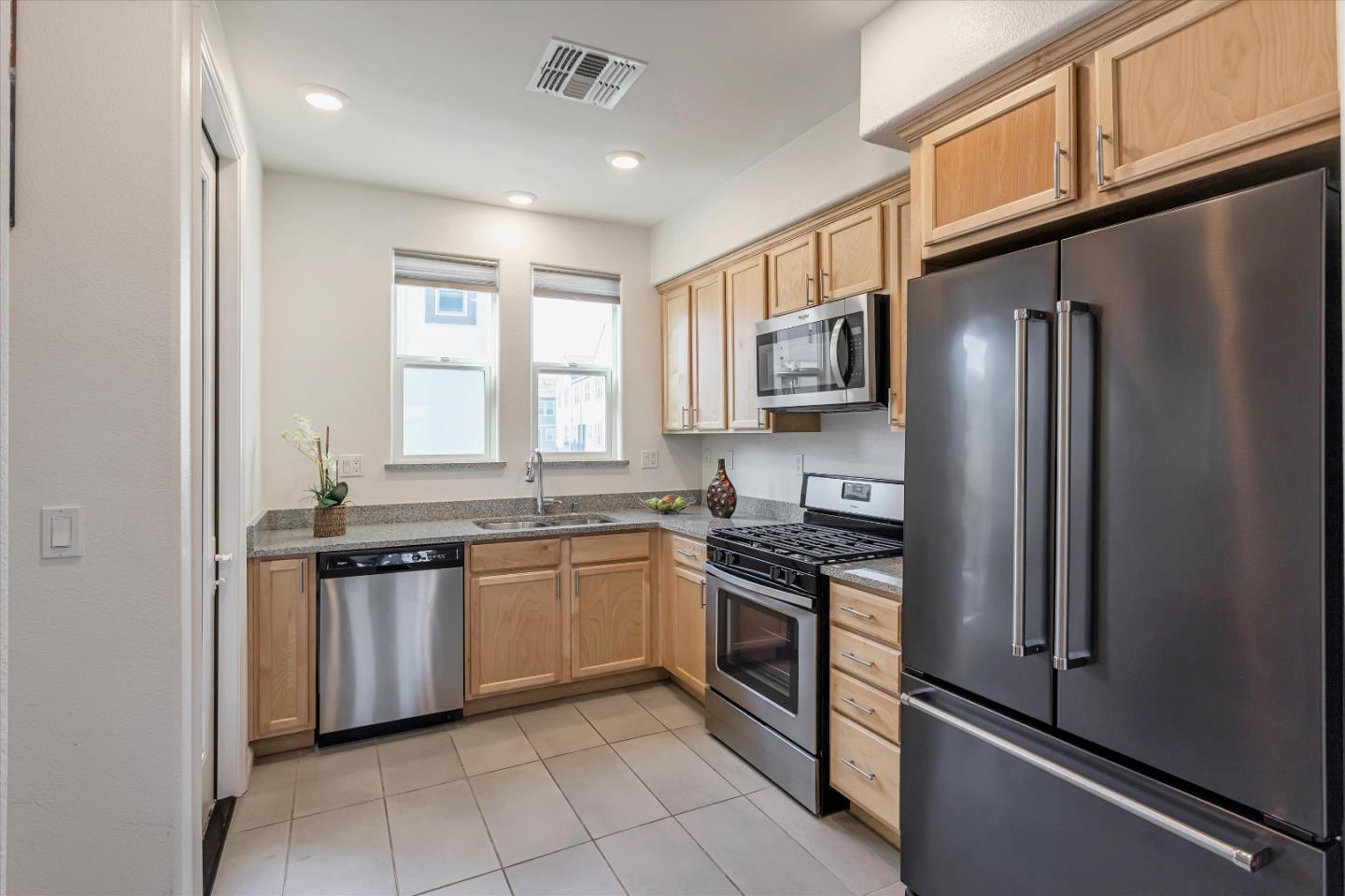 1475 Cherry Circle Milpitas, CA 95035 - Photo 4 of 33 a kitchen with stainless steel appliances granite countertop a stove top oven a sink and dishwasher