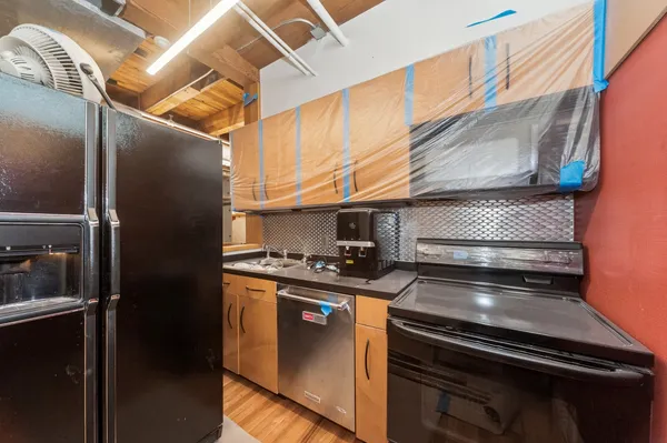 a stove top oven sitting inside of a kitchen