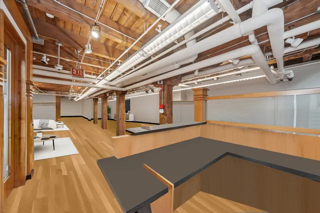 a view of a room with wooden floor