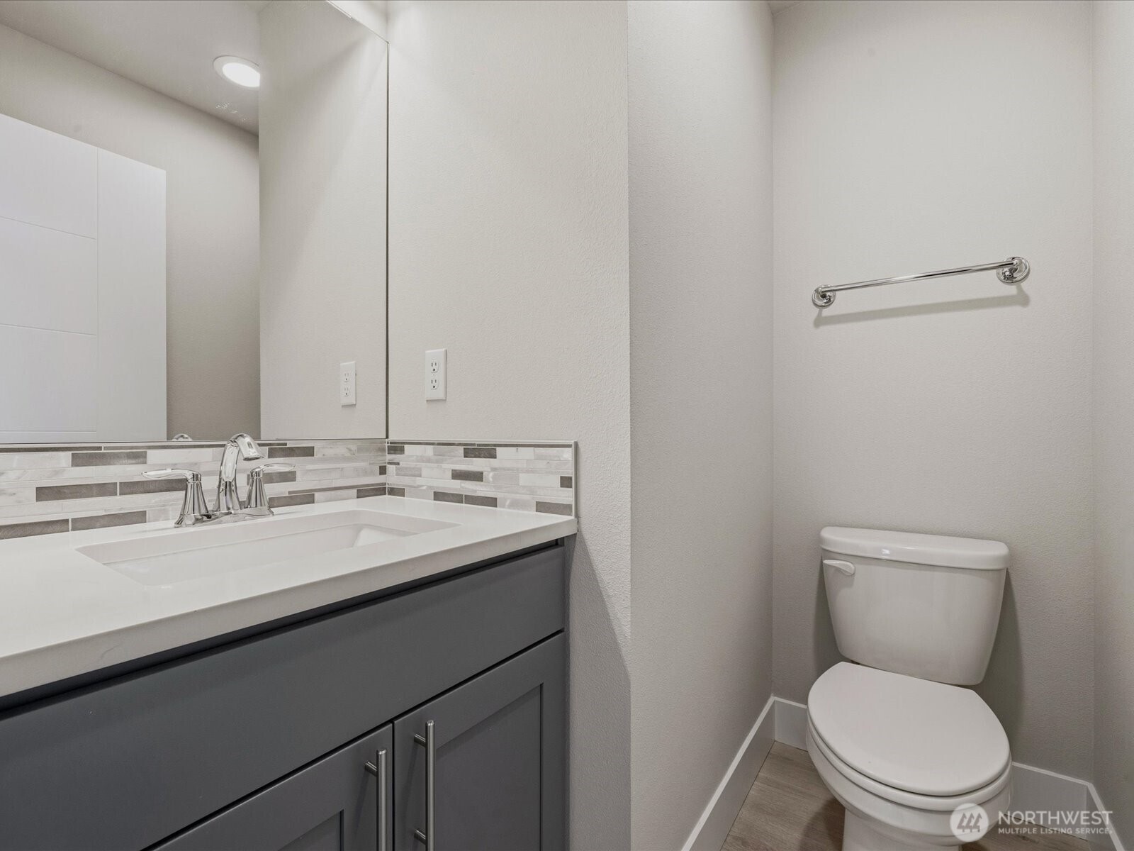 5020 148th Street Southwest, Unit B1 Edmonds, WA 98026 - Photo 12 of 31 a bathroom with a toilet a sink and mirror