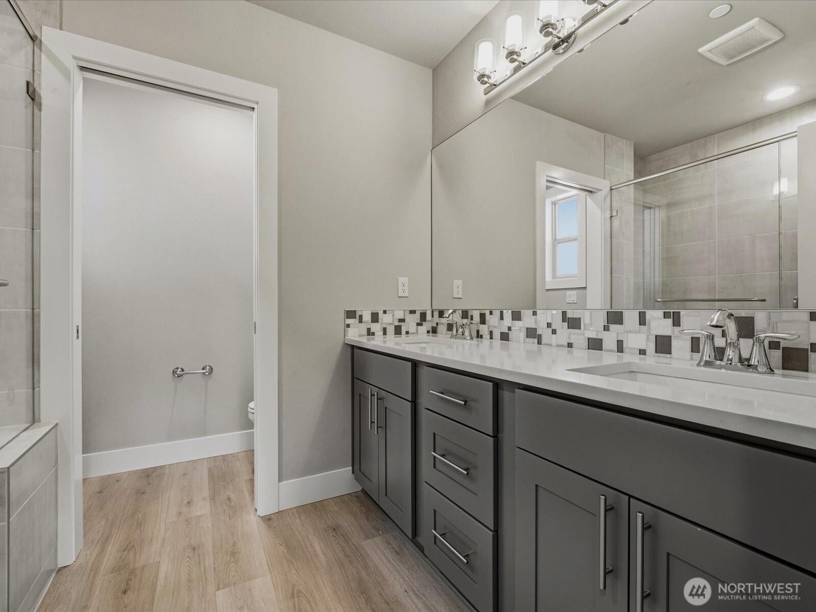 5020 148th Street Southwest, Unit B1 Edmonds, WA 98026 - Photo 18 of 31 a bathroom with a sink and a mirror