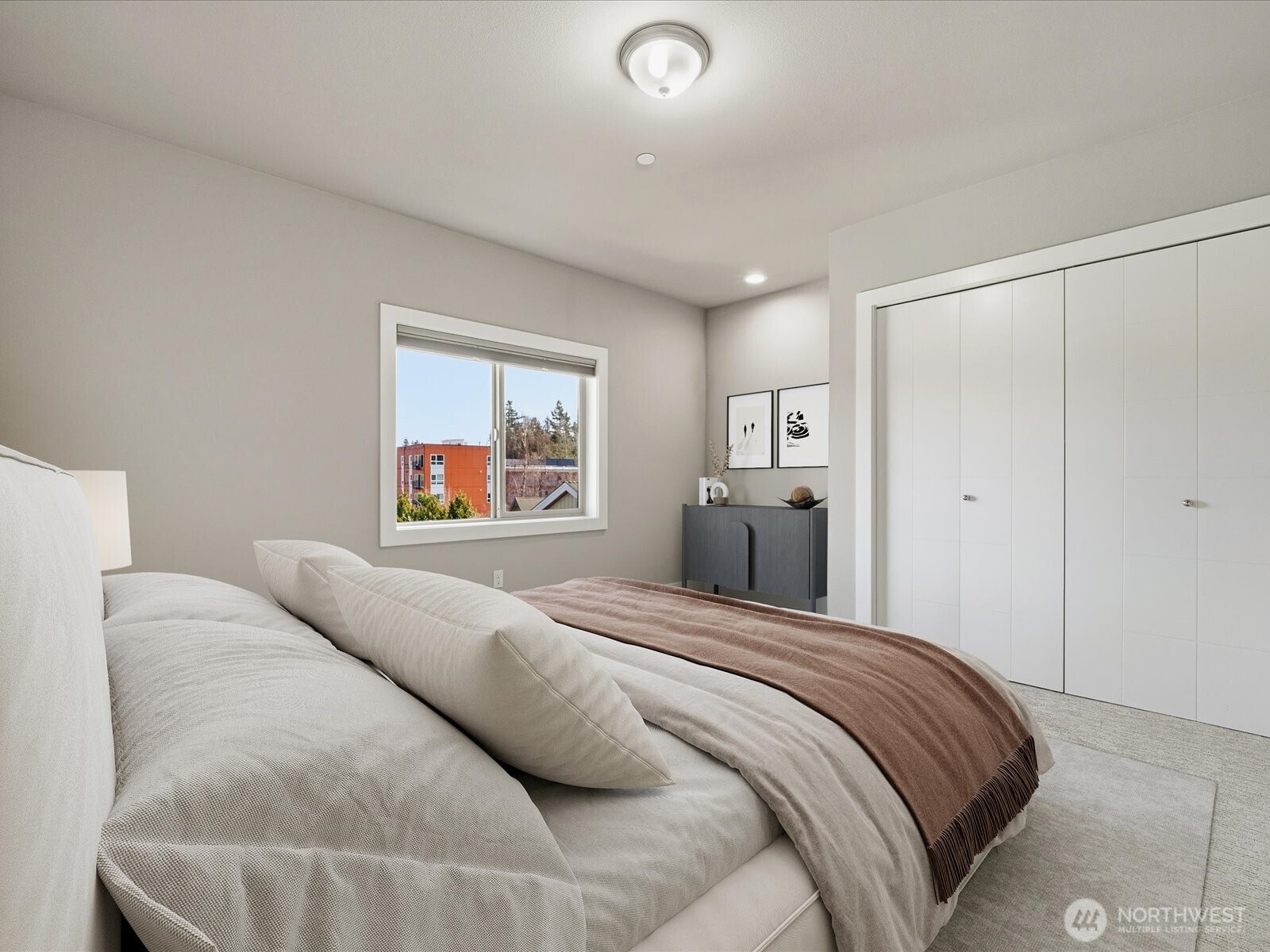 5020 148th Street Southwest, Unit B1 Edmonds, WA 98026 - Photo 20 of 31 a bedroom with a large bed and a chandelier
