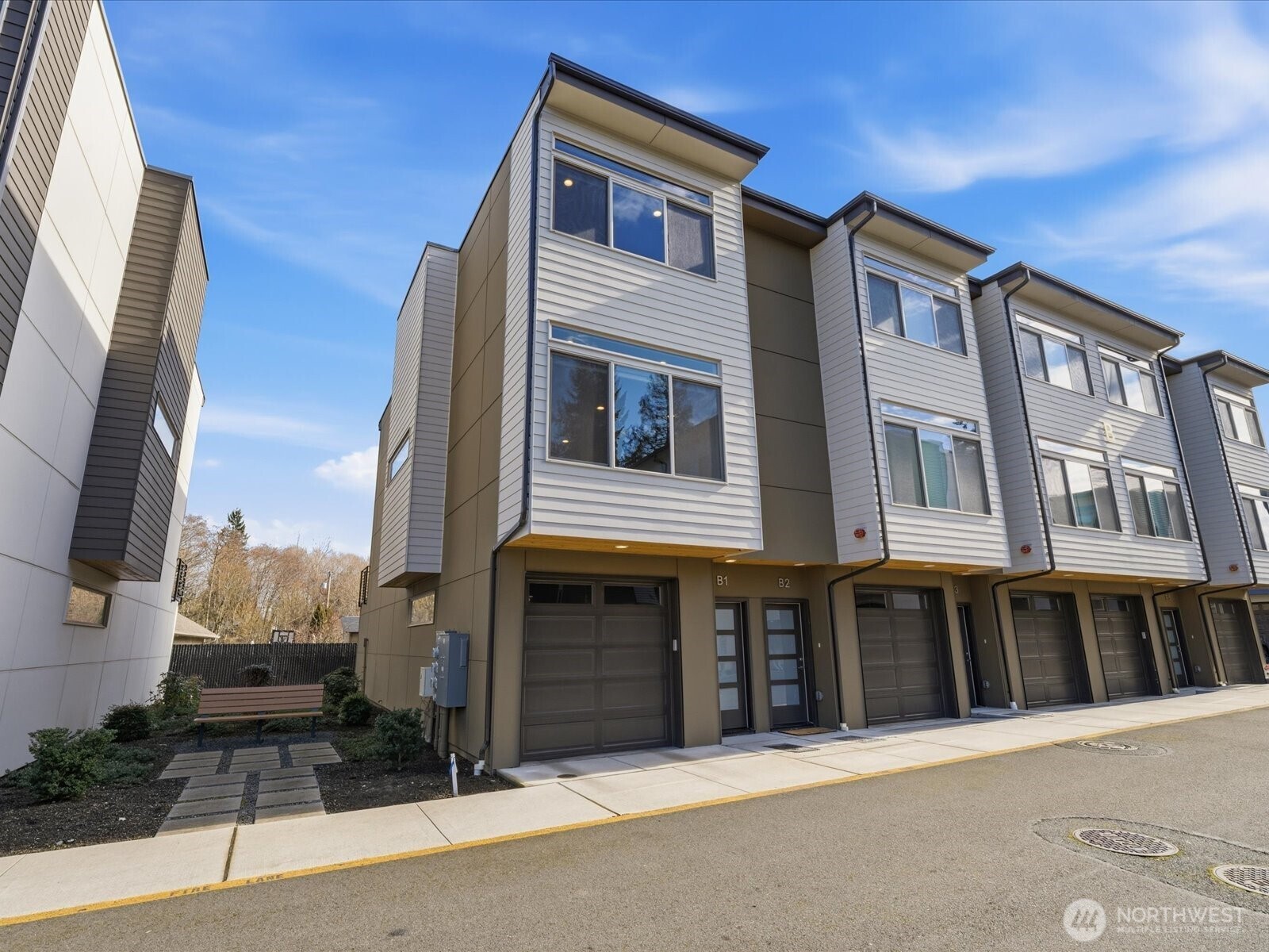 5020 148th Street Southwest, Unit B1 Edmonds, WA 98026 - Photo 2 of 31 a front view of a building with many windows