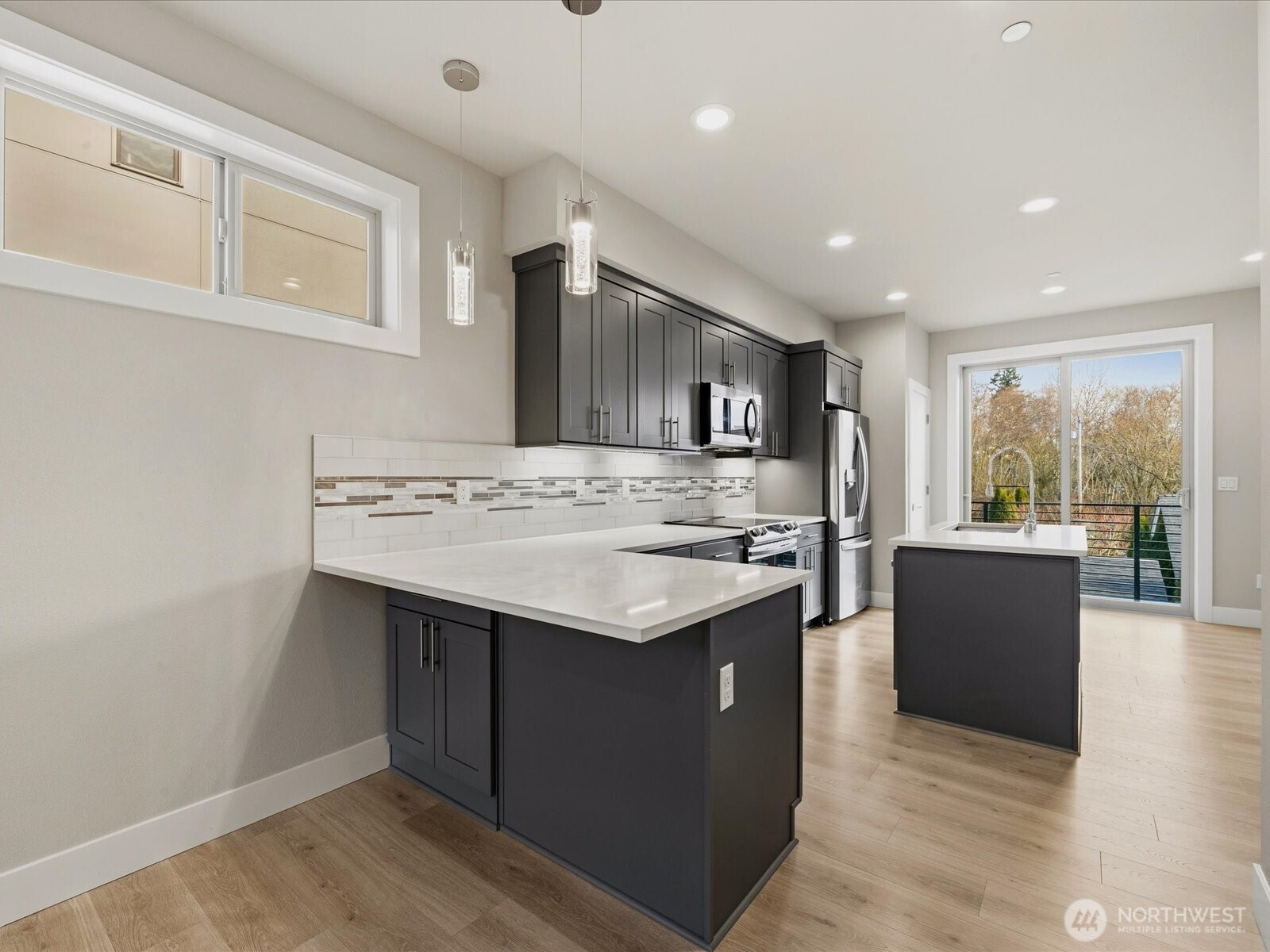 5020 148th Street Southwest, Unit B1 Edmonds, WA 98026 - Photo 5 of 31 a kitchen with a sink and a stove top oven
