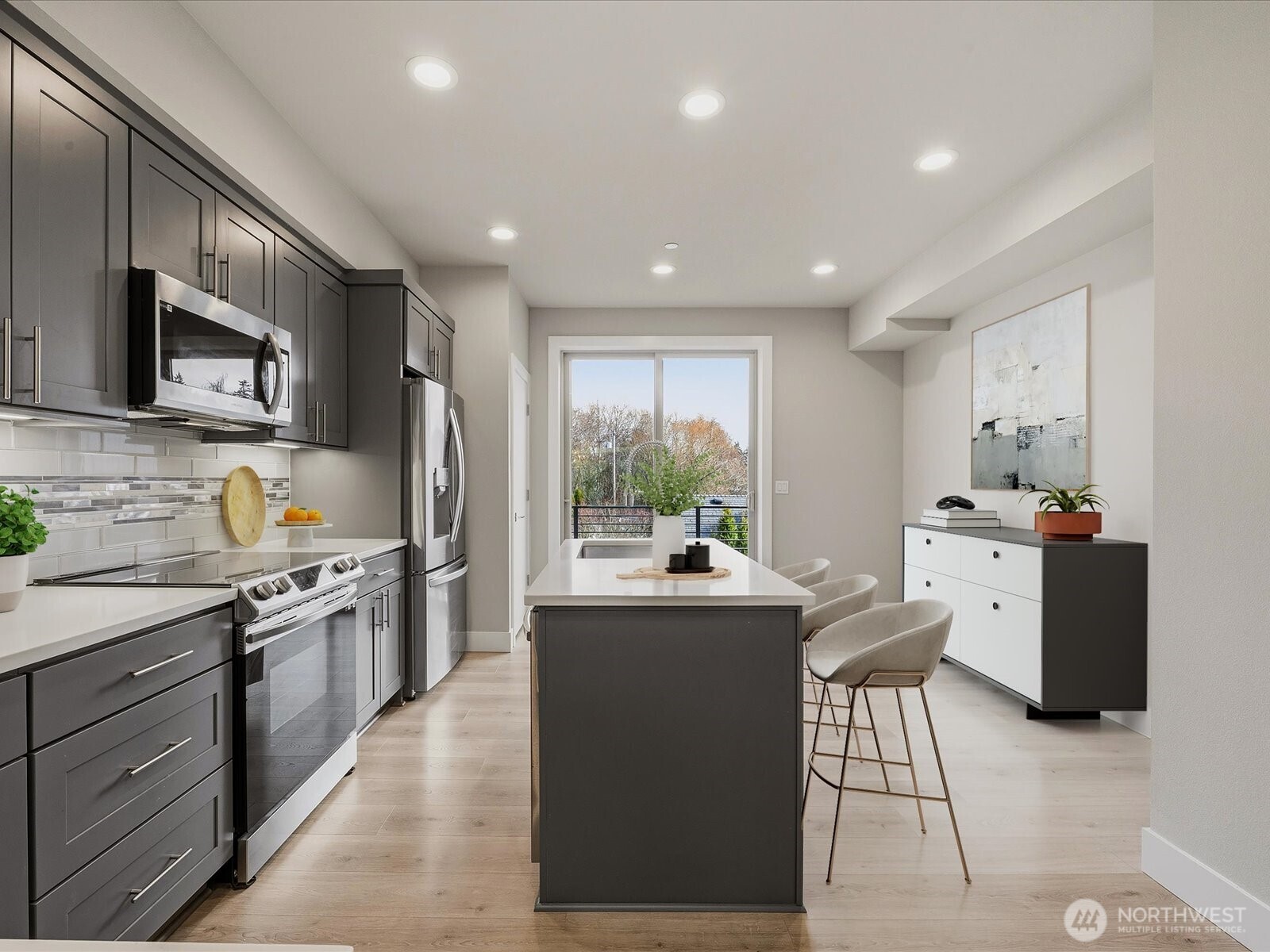 5020 148th Street Southwest, Unit B1 Edmonds, WA 98026 - Photo 6 of 31 a kitchen with kitchen island granite countertop a sink and appliances