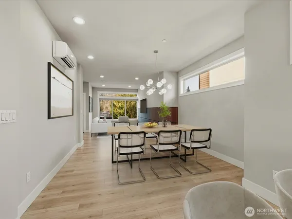 a view of a dining room with furniture and wooden floor