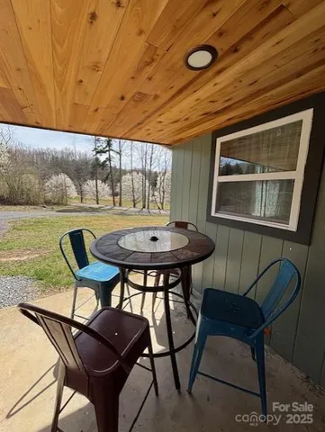 a view of a dining room with furniture and window