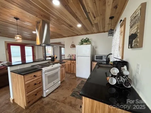 a kitchen with granite countertop a stove a refrigerator and a dishwasher