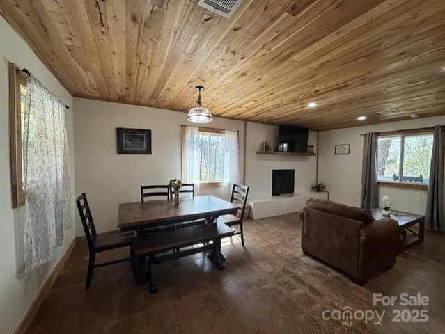 a living room with furniture a flat screen tv and a large window