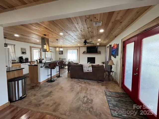 a living room with furniture and kitchen view